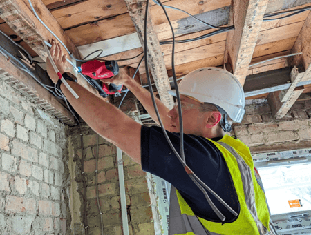 Mat from PureElectric24 fitting electrical cables on a construction site